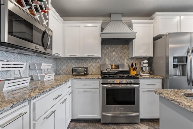 809 Dollar St, Cave Springs, AR 72718 - kitchen featuring stainless steel appliances, custom range hood, white cabinets, and backsplash