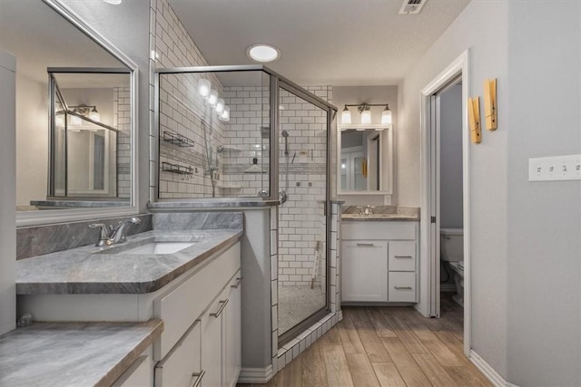809 Dollar St, Cave Springs, AR 72718 - full bathroom with a shower stall, vanity, wood finished floors, and toilet
