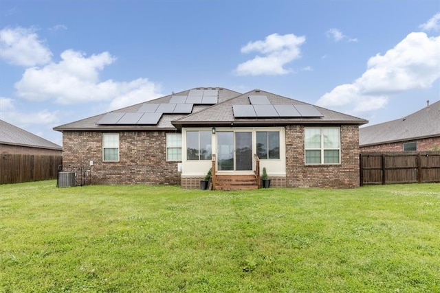 809 Dollar St, Cave Springs, AR 72718 - back of house featuring entry steps, brick siding, solar panels, central AC unit, and roof with shingles