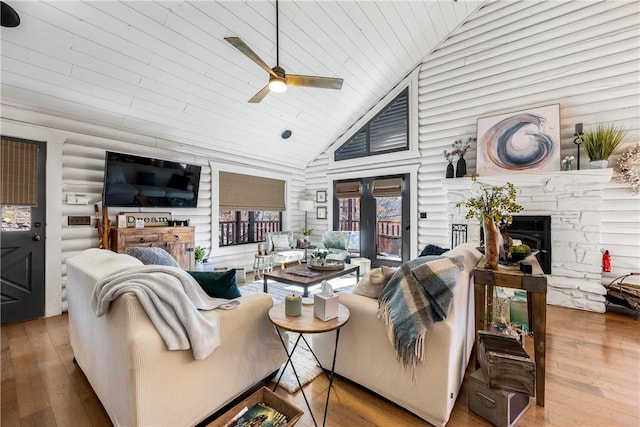 22283 N Log Cabin Dr, Sulphur Springs, AR 72768 - living room with a fireplace, ceiling fan, wood-type flooring, wood ceiling, and high vaulted ceiling