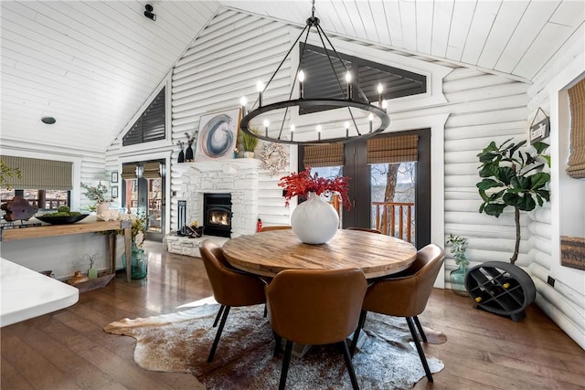 22283 N Log Cabin Dr, Sulphur Springs, AR 72768 - dining room featuring hardwood / wood-style flooring, a chandelier, a fireplace, wood ceiling, and plenty of natural light