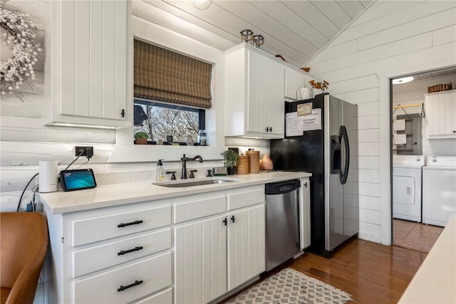 22283 N Log Cabin Dr, Sulphur Springs, AR 72768 - kitchen featuring independent washer and dryer, stainless steel appliances, a sink, lofted ceiling, and light countertops
