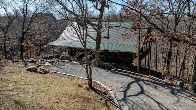 22283 N Log Cabin Dr, Sulphur Springs, AR 72768 - back of house featuring metal roof and asphalt driveway