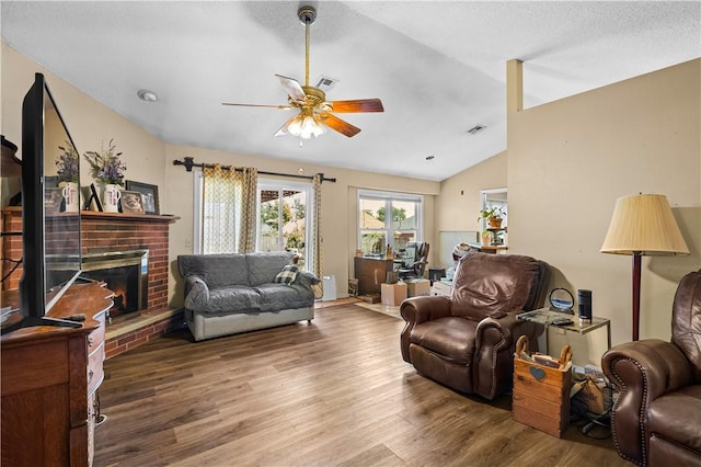 658 Walnut Ridge St, Centerton, AR 72719 - living room featuring lofted ceiling, wood finished floors, ceiling fan, and a fireplace