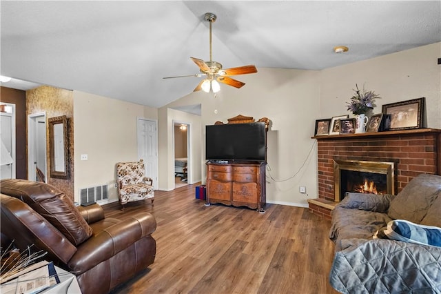 658 Walnut Ridge St, Centerton, AR 72719 - living area featuring a ceiling fan, wood finished floors, a brick fireplace, baseboards, and lofted ceiling