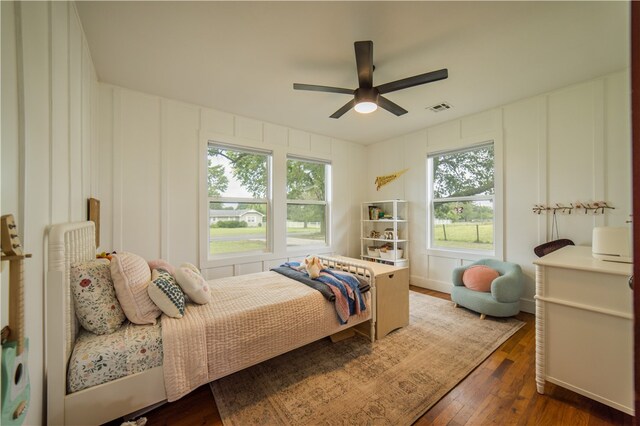 20608 Keck Rd, Siloam Springs, AR 72761 - bedroom featuring hardwood / wood-style floors, a decorative wall, and a ceiling fan
