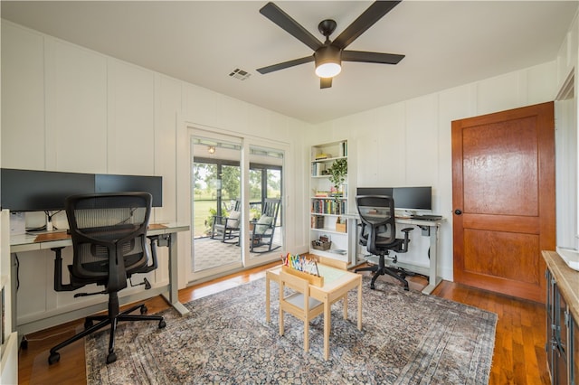20608 Keck Rd, Siloam Springs, AR 72761 - office featuring ceiling fan, a decorative wall, and wood finished floors