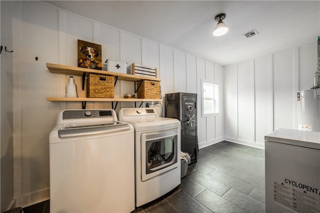 20608 Keck Rd, Siloam Springs, AR 72761 - washroom featuring a decorative wall, separate washer and dryer, and water heater