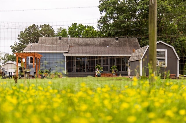 20608 Keck Rd, Siloam Springs, AR 72761 - back of property with a sunroom, a shingled roof, a lawn, and a pergola