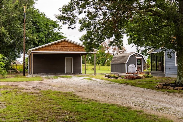 20608 Keck Rd, Siloam Springs, AR 72761 - garage with dirt driveway, a storage unit, and a carport