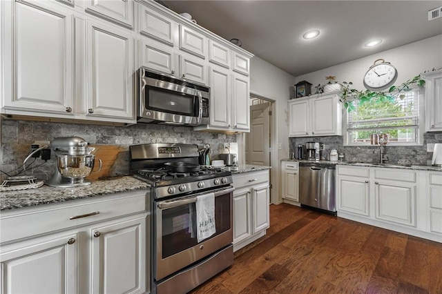 757 Harper Dr, Pea Ridge, AR 72751 - kitchen with appliances with stainless steel finishes, a sink, white cabinetry, tasteful backsplash, and recessed lighting