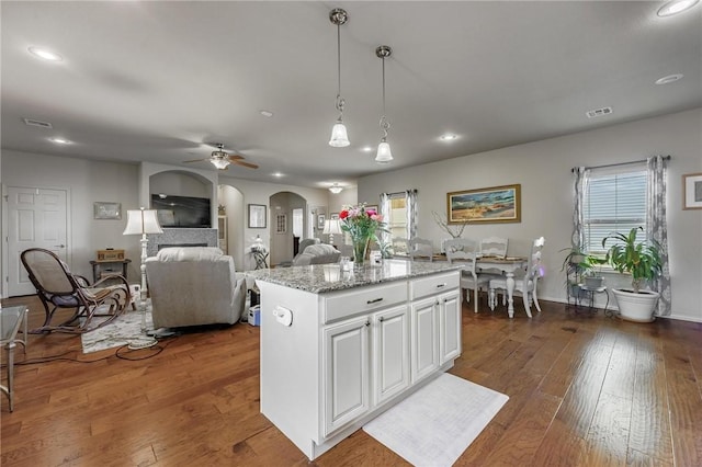 757 Harper Dr, Pea Ridge, AR 72751 - kitchen with arched walkways, recessed lighting, decorative light fixtures, white cabinets, and a ceiling fan
