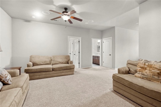 6401 S 42nd St, Rogers, AR 72758 - living area featuring light carpet, ceiling fan, and baseboards