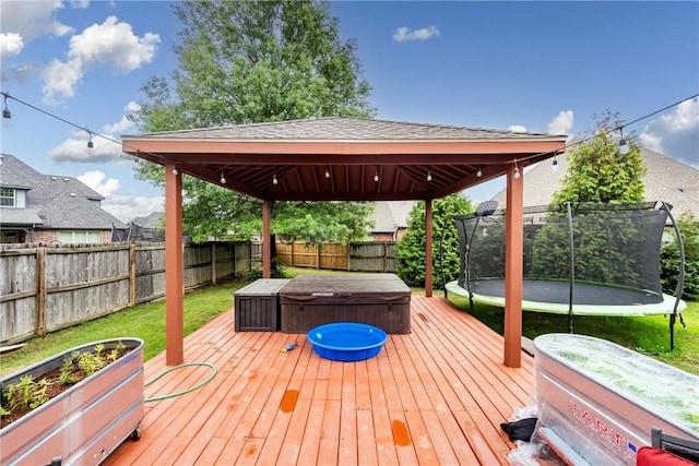 6401 S 42nd St, Rogers, AR 72758 - deck featuring a covered hot tub, a trampoline, and a gazebo