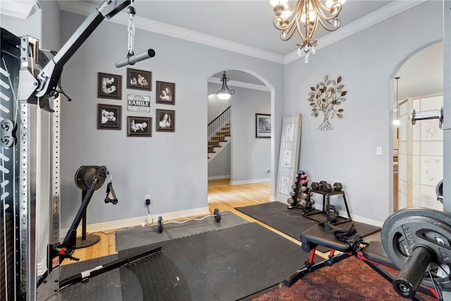 6401 S 42nd St, Rogers, AR 72758 - exercise room featuring arched walkways, wood finished floors, crown molding, a chandelier, and baseboards