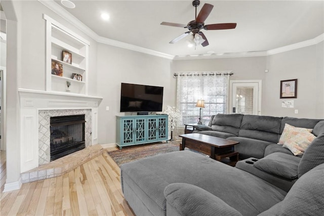 6401 S 42nd St, Rogers, AR 72758 - living room featuring wood finished floors, a ceiling fan, crown molding, a fireplace, and baseboards