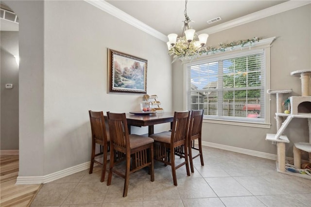 6401 S 42nd St, Rogers, AR 72758 - dining space featuring a chandelier, crown molding, tile patterned floors, and baseboards