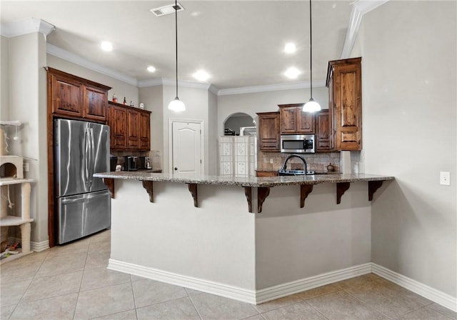 6401 S 42nd St, Rogers, AR 72758 - kitchen with stainless steel appliances, light stone counters, tasteful backsplash, a peninsula, and crown molding