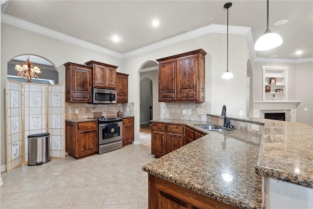 6401 S 42nd St, Rogers, AR 72758 - kitchen with appliances with stainless steel finishes, a sink, arched walkways, dark stone countertops, and backsplash