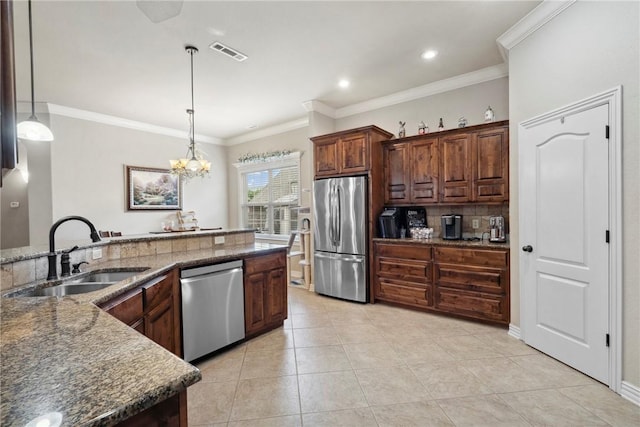 6401 S 42nd St, Rogers, AR 72758 - kitchen with appliances with stainless steel finishes, a sink, decorative light fixtures, light tile patterned flooring, and dark stone countertops