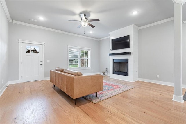 1265 Cassia, Tontitown, AR 72762 - living area with light wood-style floors, a ceiling fan, a fireplace, ornamental molding, and baseboards