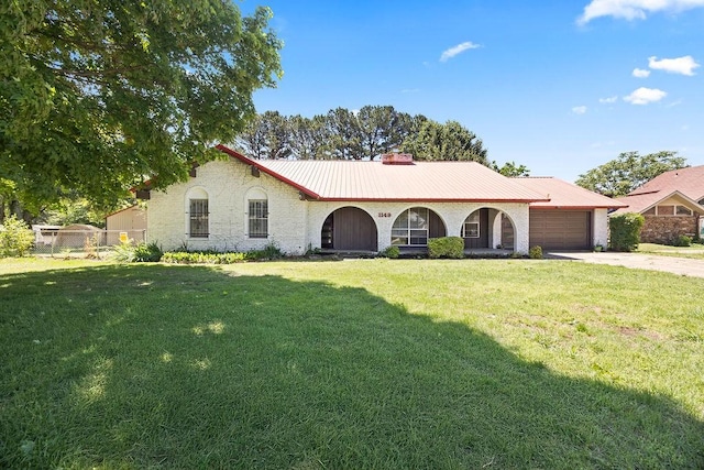 1149 Sunrise Ave, Springdale, AR 72764 - view of front of property with driveway, an attached garage, a chimney, and metal roof