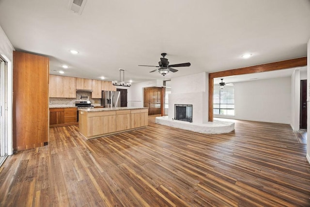 1149 Sunrise Ave, Springdale, AR 72764 - kitchen with stainless steel appliances, open floor plan, light brown cabinets, a ceiling fan, and dark wood-type flooring