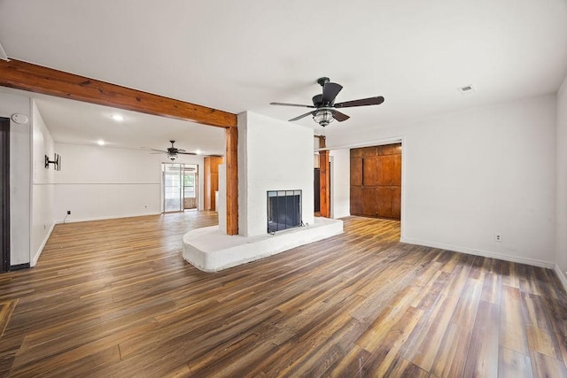 1149 Sunrise Ave, Springdale, AR 72764 - unfurnished living room with ceiling fan, wood finished floors, a fireplace with raised hearth, baseboards, and beamed ceiling