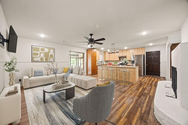 1149 Sunrise Ave, Springdale, AR 72764 - living area with a ceiling fan, dark wood finished floors, recessed lighting, a fireplace with raised hearth, and a chandelier
