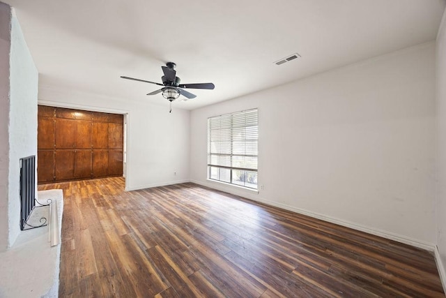 1149 Sunrise Ave, Springdale, AR 72764 - unfurnished living room with wood finished floors, ceiling fan, and baseboards