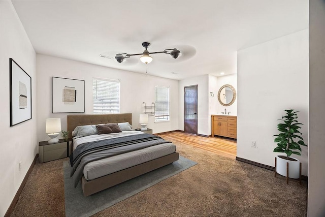 1149 Sunrise Ave, Springdale, AR 72764 - bedroom with light carpet, baseboards, a sink, ensuite bathroom, and a ceiling fan