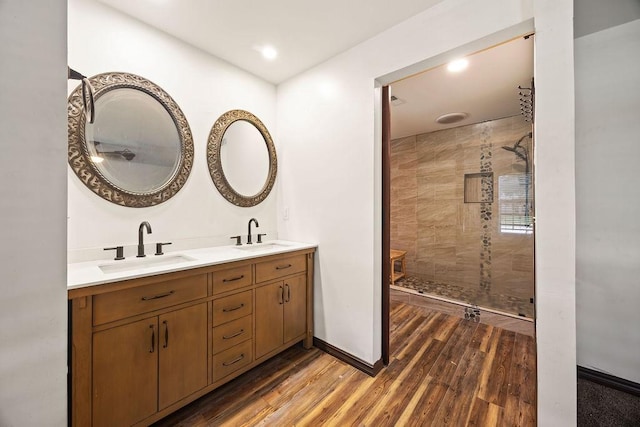 1149 Sunrise Ave, Springdale, AR 72764 - full bathroom with double vanity, wood finished floors, a tile shower, and baseboards