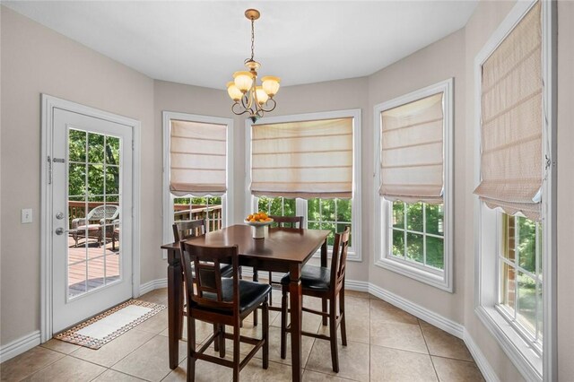 8200 Titleist Cir, Rogers, AR 72756 - dining room with a chandelier, light tile patterned floors, and plenty of natural light