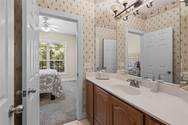 8200 Titleist Cir, Rogers, AR 72756 - ensuite bathroom featuring vanity, wallpapered walls, a chandelier, baseboards, and ceiling fan