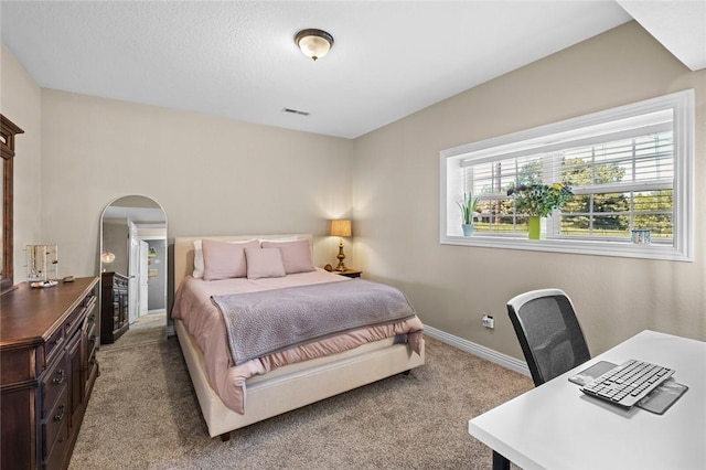 8200 Titleist Cir, Rogers, AR 72756 - bedroom with light colored carpet, baseboards, arched walkways, and a desk