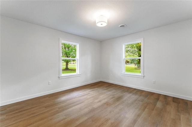 5479 Bob Mills Rd, Springdale, AR 72762 - empty room featuring healthy amount of natural light, wood finished floors, and baseboards