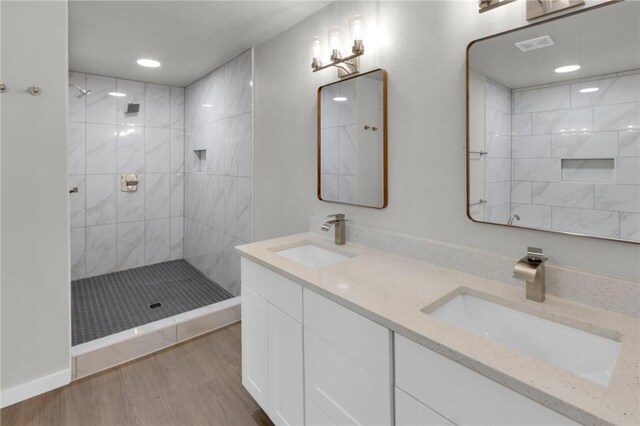 1115 Eicher Ave, Springdale, AR 72764 - full bathroom with tiled shower, double vanity, wood finished floors, and recessed lighting