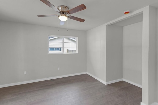 1115 Eicher Ave, Springdale, AR 72764 - spare room with dark wood-type flooring, baseboards, ceiling fan, and a smoke detector