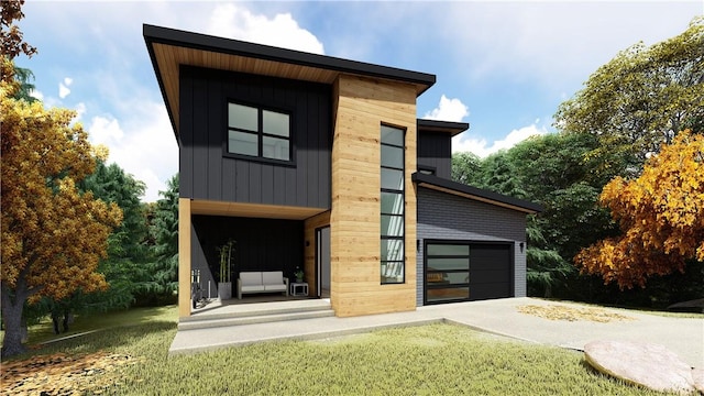 13 Abbotsley Ln, Bella Vista, AR 72714 - view of front facade featuring concrete driveway, a garage, board and batten siding, and a front lawn