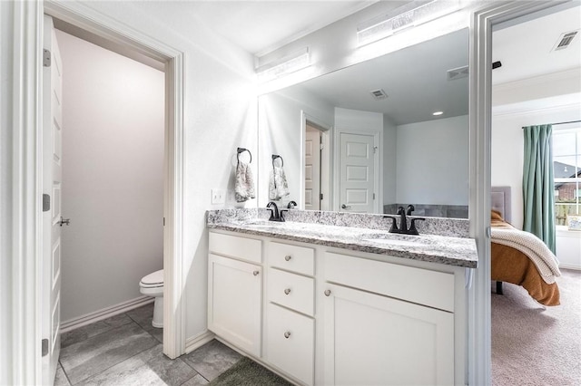 7533 Devonshire Ave, Springdale, AR 72762 - bathroom featuring toilet, double vanity, ensuite bathroom, and baseboards