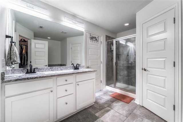 7533 Devonshire Ave, Springdale, AR 72762 - full bathroom featuring a shower stall, double vanity, a walk in closet, and recessed lighting