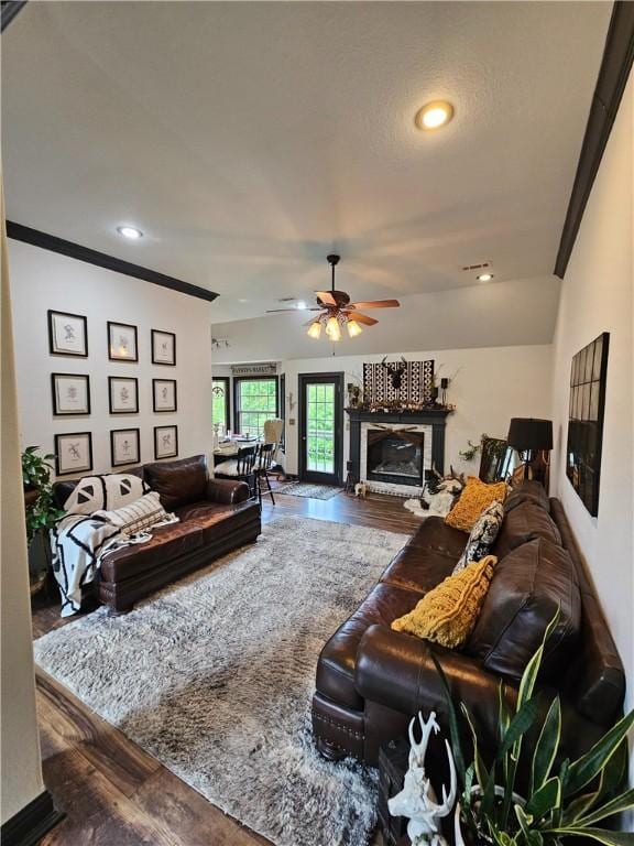 3 Rhonda Ln, Bella Vista, AR 72715 - living room with a ceiling fan, wood finished floors, a glass covered fireplace, recessed lighting, and ornamental molding