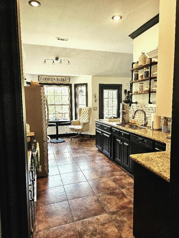 3 Rhonda Ln, Bella Vista, AR 72715 - kitchen with dark cabinets, a textured ceiling, a sink, open shelves, and plenty of natural light