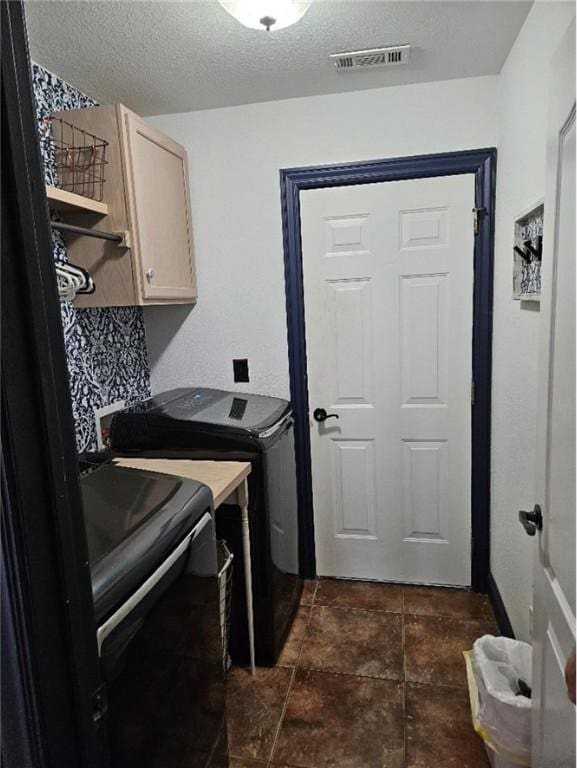 3 Rhonda Ln, Bella Vista, AR 72715 - washroom with independent washer and dryer, cabinet space, a textured ceiling, and dark tile patterned flooring