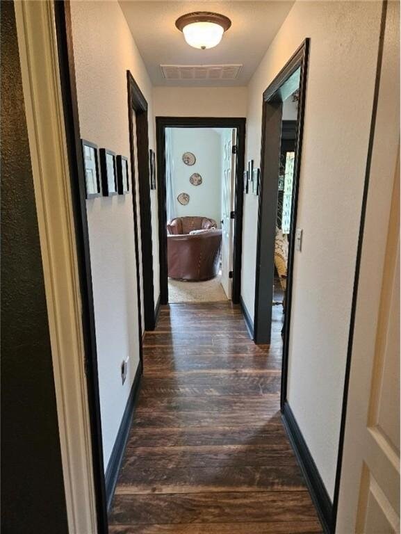 3 Rhonda Ln, Bella Vista, AR 72715 - hall with dark wood-style floors and baseboards