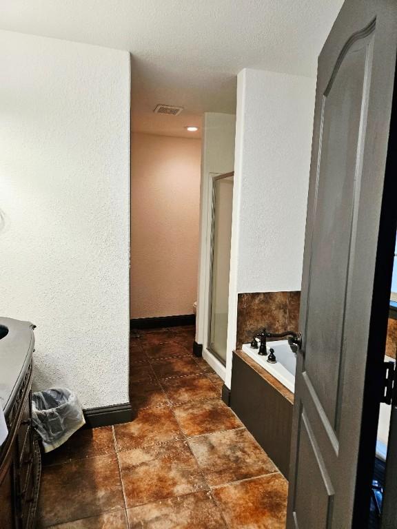 3 Rhonda Ln, Bella Vista, AR 72715 - full bathroom with a shower stall, vanity, a bath, and baseboards