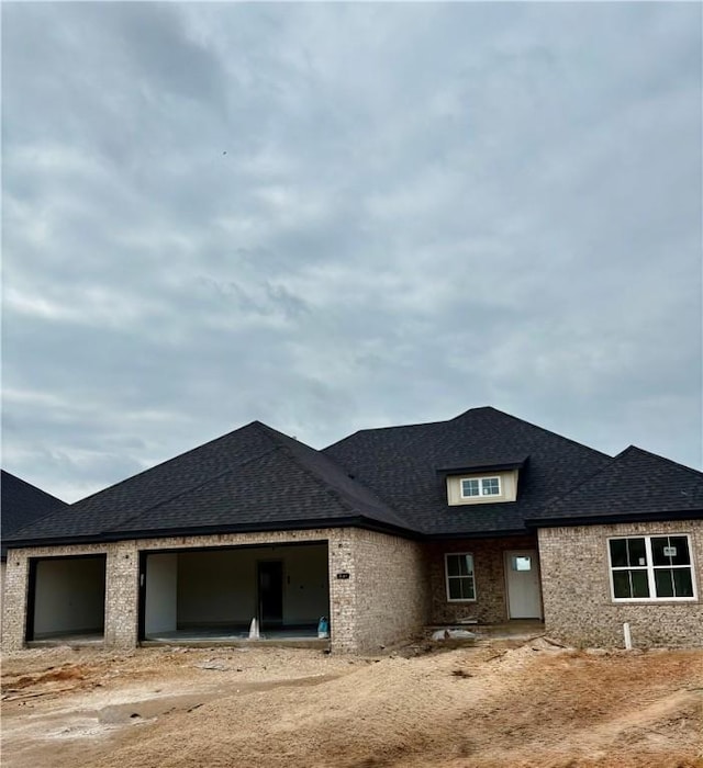841 Bellagiola Ave, Tontitown, AR 72762 - view of front of house featuring an attached garage, a shingled roof, and brick siding