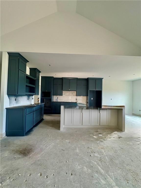 841 Bellagiola Ave, Tontitown, AR 72762 - kitchen featuring decorative backsplash, high vaulted ceiling, open shelves, and a center island