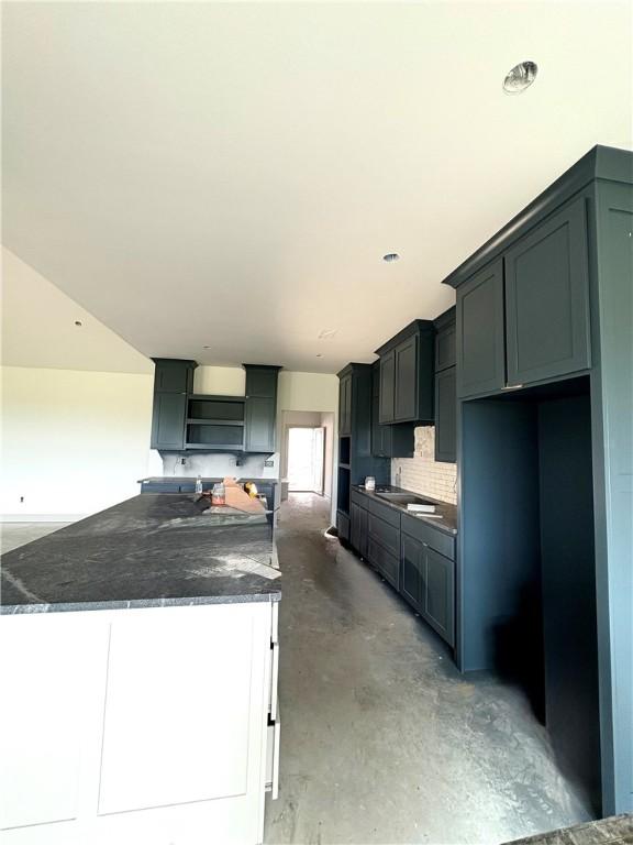 841 Bellagiola Ave, Tontitown, AR 72762 - kitchen with open shelves, a kitchen island, and concrete floors