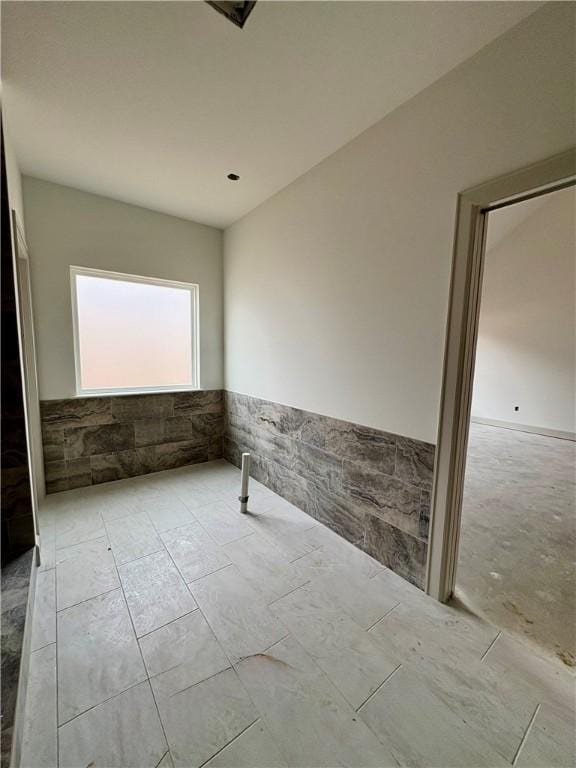 841 Bellagiola Ave, Tontitown, AR 72762 - empty room featuring a wainscoted wall and tile walls